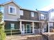 Charming townhome exterior with a welcoming front porch and a well maintained lawn at 14700 E 104Th Ave # 2605, Commerce City, CO 80022