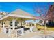 Inviting community gazebo with stone accents, picnic tables and sunny surroundings at 14700 E 104Th Ave # 2605, Commerce City, CO 80022