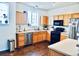Kitchen features wood cabinets, stainless steel appliances, and hardwood floors at 14700 E 104Th Ave # 2605, Commerce City, CO 80022