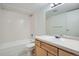 Clean bathroom with a tub, shower, tile walls, and a wood vanity at 2225 Buchtel Blvd # 1003, Denver, CO 80210