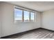 Bright bedroom featuring a large window and sleek gray flooring at 2225 Buchtel Blvd # 1003, Denver, CO 80210