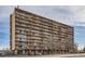 A full exterior view of a multi-story building with long rows of balconies and street views at 2225 Buchtel Blvd # 1003, Denver, CO 80210