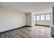 An empty room with modern flooring and a window with views, perfect for customization at 2225 Buchtel Blvd # 1003, Denver, CO 80210