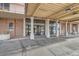 Building entrance with a covered walkway and glass doors and pillars for support at 2225 Buchtel Blvd # 1003, Denver, CO 80210