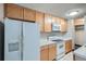 Well-equipped kitchen features white appliances, wood cabinets, and a range oven at 2225 Buchtel Blvd # 1003, Denver, CO 80210