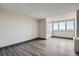 Spacious living area featuring modern gray flooring and a large window offering ample natural light at 2225 Buchtel Blvd # 1003, Denver, CO 80210