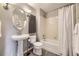 Elegant bathroom with a pedestal sink, modern fixtures, and a shower-tub combination at 9481 E Mansfield Ave # 301, Aurora, CO 80014