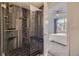 Luxurious tiled shower with built-in bench, rainfall showerhead, and bedroom view at 9481 E Mansfield Ave # 301, Aurora, CO 80014