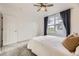 Bedroom featuring a large window with neighborhood views and a comfortable bed at 9481 E Mansfield Ave # 301, Aurora, CO 80014