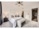 Bright bedroom with a stylish bed, bench, and view of the hallway and bathroom at 9481 E Mansfield Ave # 301, Aurora, CO 80014