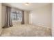 Empty bedroom with neutral walls, carpeted floor, and a large window with curtains at 9481 E Mansfield Ave # 301, Aurora, CO 80014