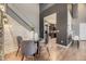 Bright dining area showcases a glass table, modern chairs, a stacked stone wall, and staircase access at 9481 E Mansfield Ave # 301, Aurora, CO 80014