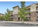 Charming brick apartment building featuring multiple balconies and lush green trees in a well-maintained community at 9481 E Mansfield Ave # 301, Aurora, CO 80014