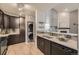 Stylish kitchen boasts stainless steel appliances, modern cabinets, and stacked washer and dryer units at 9481 E Mansfield Ave # 301, Aurora, CO 80014