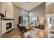 Inviting living room boasts a brick fireplace, vaulted ceilings, and a sliding door to the outdoor balcony at 9481 E Mansfield Ave # 301, Aurora, CO 80014