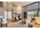 Bright living room features wood floors, a brick fireplace, and access to the balcony through a sliding glass door at 9481 E Mansfield Ave # 301, Aurora, CO 80014