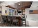 Entertainment bar in basement with stylish counter seating and ample shelving at 26989 E Friend Pl, Aurora, CO 80016