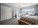 Inviting bedroom with a work desk, chandelier, a storage bench, and lots of natural light at 26989 E Friend Pl, Aurora, CO 80016