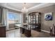 Formal dining room boasting a large window and elegant chandelier at 26989 E Friend Pl, Aurora, CO 80016