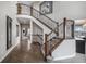 Elegant foyer with a grand staircase, hardwood floors, and soaring ceilings creates a welcoming entrance at 26989 E Friend Pl, Aurora, CO 80016
