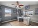Stylish home office with aviation themed decor, plenty of natural light, and a unique metal desk at 26989 E Friend Pl, Aurora, CO 80016