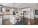 Modern kitchen features a large island, stainless steel appliances, and stylish pendant lighting at 26989 E Friend Pl, Aurora, CO 80016