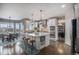 Gourmet kitchen boasts white cabinets, a large center island with seating, and stainless steel appliances at 26989 E Friend Pl, Aurora, CO 80016