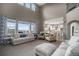 Spacious living room with soaring ceilings, plush seating, and an open floor plan perfect for entertaining at 26989 E Friend Pl, Aurora, CO 80016