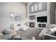Inviting living room with vaulted ceilings, a fireplace, and neutral tones, providing a relaxing atmosphere at 26989 E Friend Pl, Aurora, CO 80016