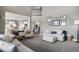Open-concept living room seamlessly connects to the kitchen, featuring comfortable seating and stylish decor at 26989 E Friend Pl, Aurora, CO 80016