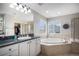 Elegant main bathroom with a soaking tub, walk-in shower, and marble countertops at 26989 E Friend Pl, Aurora, CO 80016