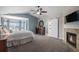 Spacious main bedroom with a fireplace, ensuite bathroom, and a beautiful bay window at 26989 E Friend Pl, Aurora, CO 80016