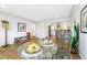 Bright dining area with hardwood floors and view into updated kitchen at 1180 E Girard Ave, Englewood, CO 80113