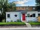 Charming bungalow with red door and well-maintained lawn at 1180 E Girard Ave, Englewood, CO 80113