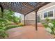 Enjoy this outdoor living space with a pergola, lush landscaping, and stone accents at 23870 E Dorado Pl, Aurora, CO 80016
