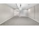 Finished basement with carpet and modern light fixtures and views into other rooms at 23870 E Dorado Pl, Aurora, CO 80016