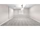 Spacious basement area with neutral walls, carpet flooring, and a modern lighting fixture at 23870 E Dorado Pl, Aurora, CO 80016