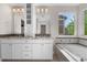 Bright bathroom with dual sinks, granite countertops, and a large soaking tub with a window view at 23870 E Dorado Pl, Aurora, CO 80016