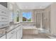 Bright bathroom featuring a separate shower, bathtub, and double sink vanity with granite countertops at 23870 E Dorado Pl, Aurora, CO 80016