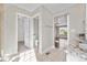 Bathroom with tiled floors, granite counters, toilet room and view into bright living space at 23870 E Dorado Pl, Aurora, CO 80016