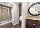 Bathroom with updated fixtures and granite countertops, shower with glass door, and unique decorative tile at 23870 E Dorado Pl, Aurora, CO 80016