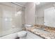 Bathroom featuring a granite vanity, tiled walls, and a glass-enclosed tub and shower at 23870 E Dorado Pl, Aurora, CO 80016