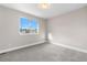 Bright, carpeted bedroom features a large window offering plenty of natural light at 23870 E Dorado Pl, Aurora, CO 80016