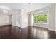 Dining room with dark hardwood floors, a large window with natural light, and two decorative chandeliers at 23870 E Dorado Pl, Aurora, CO 80016