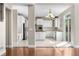 Modern kitchen boasts all-white cabinetry, stainless appliances, and marble tile flooring at 23870 E Dorado Pl, Aurora, CO 80016