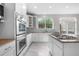 Modern kitchen features stainless steel appliances, granite countertops, and white cabinetry at 23870 E Dorado Pl, Aurora, CO 80016
