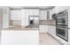 Well-equipped kitchen with stainless steel appliances, island cooktop and stone countertops at 23870 E Dorado Pl, Aurora, CO 80016