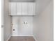 Functional laundry room with overhead cabinets and tiled floor at 23870 E Dorado Pl, Aurora, CO 80016