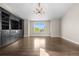 Large living room with hardwood floors, a built-in entertainment center, and a large window for natural light at 23870 E Dorado Pl, Aurora, CO 80016