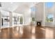 Bright living room featuring a fireplace, hardwood floors, high ceilings, and lots of natural light at 23870 E Dorado Pl, Aurora, CO 80016
